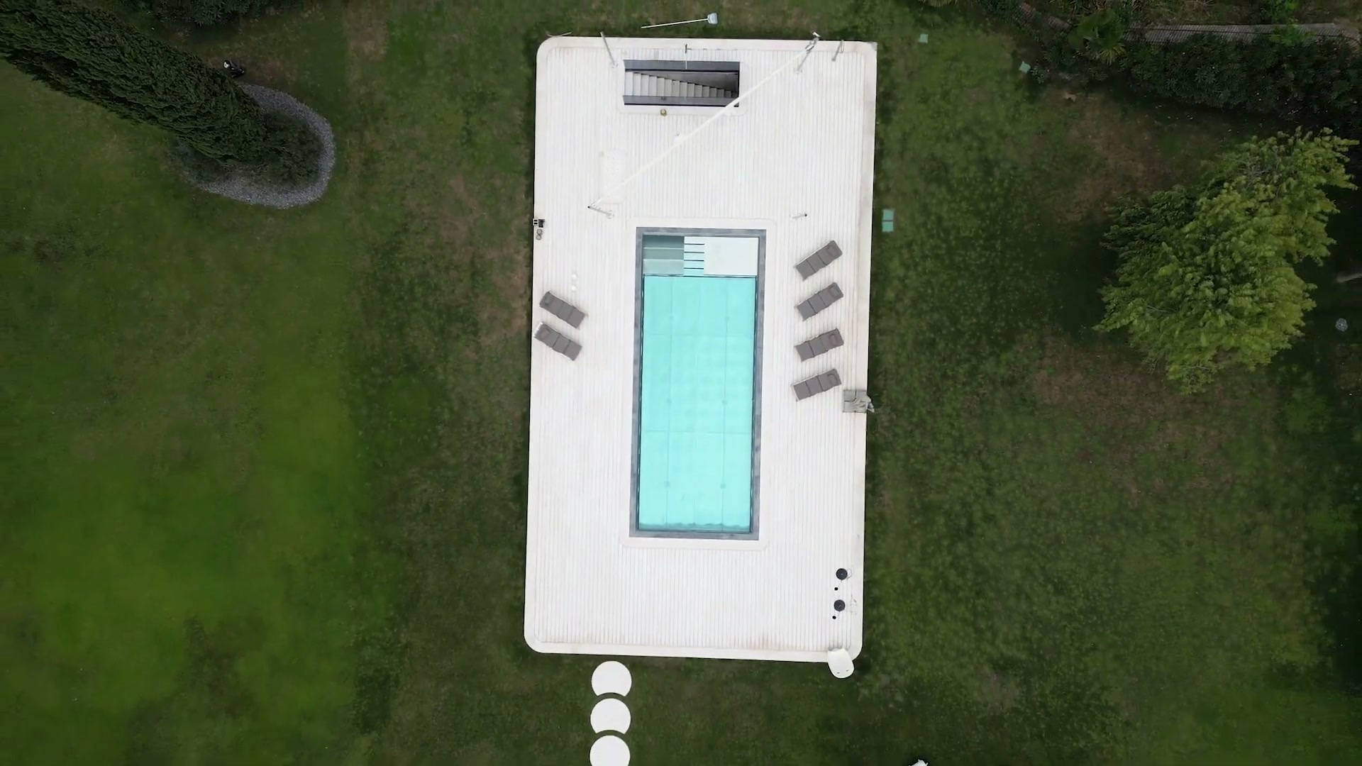 Natural stone plank decking beside a pool